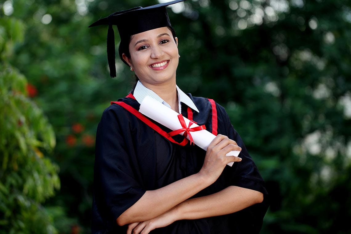 girl holding her diploma earned through an online high school program