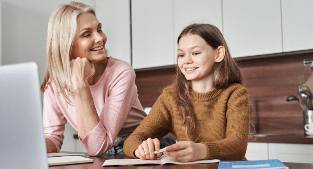 proud mother reviewing daughters online homework