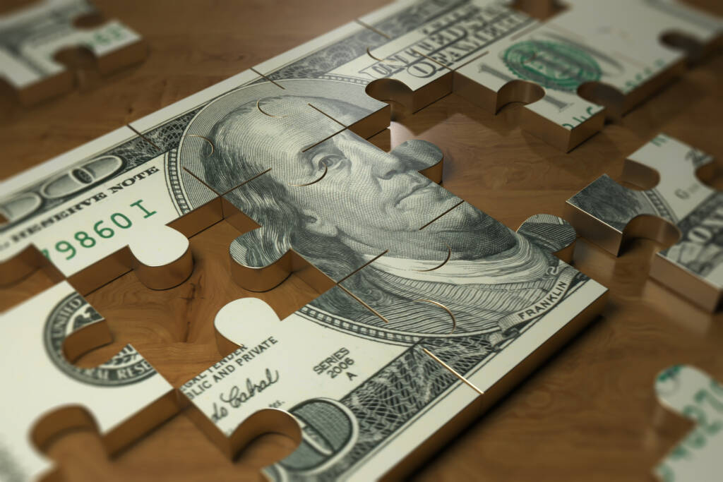 Dollar puzzle piece on the wood table. finance and business industry