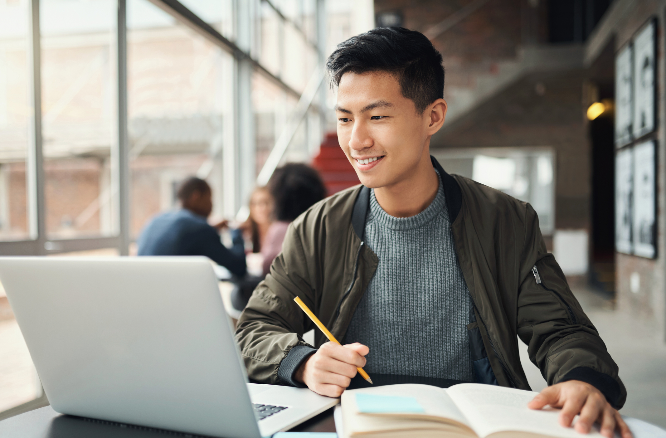 College student, asian man and studying on laptop at campus,