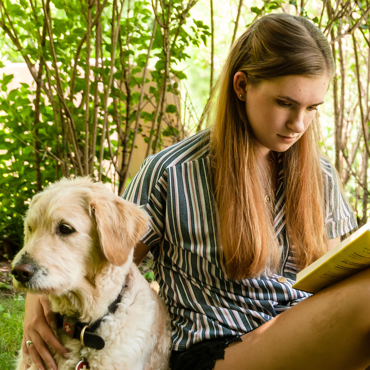 reading-with-dog-outside student reading with dog outside