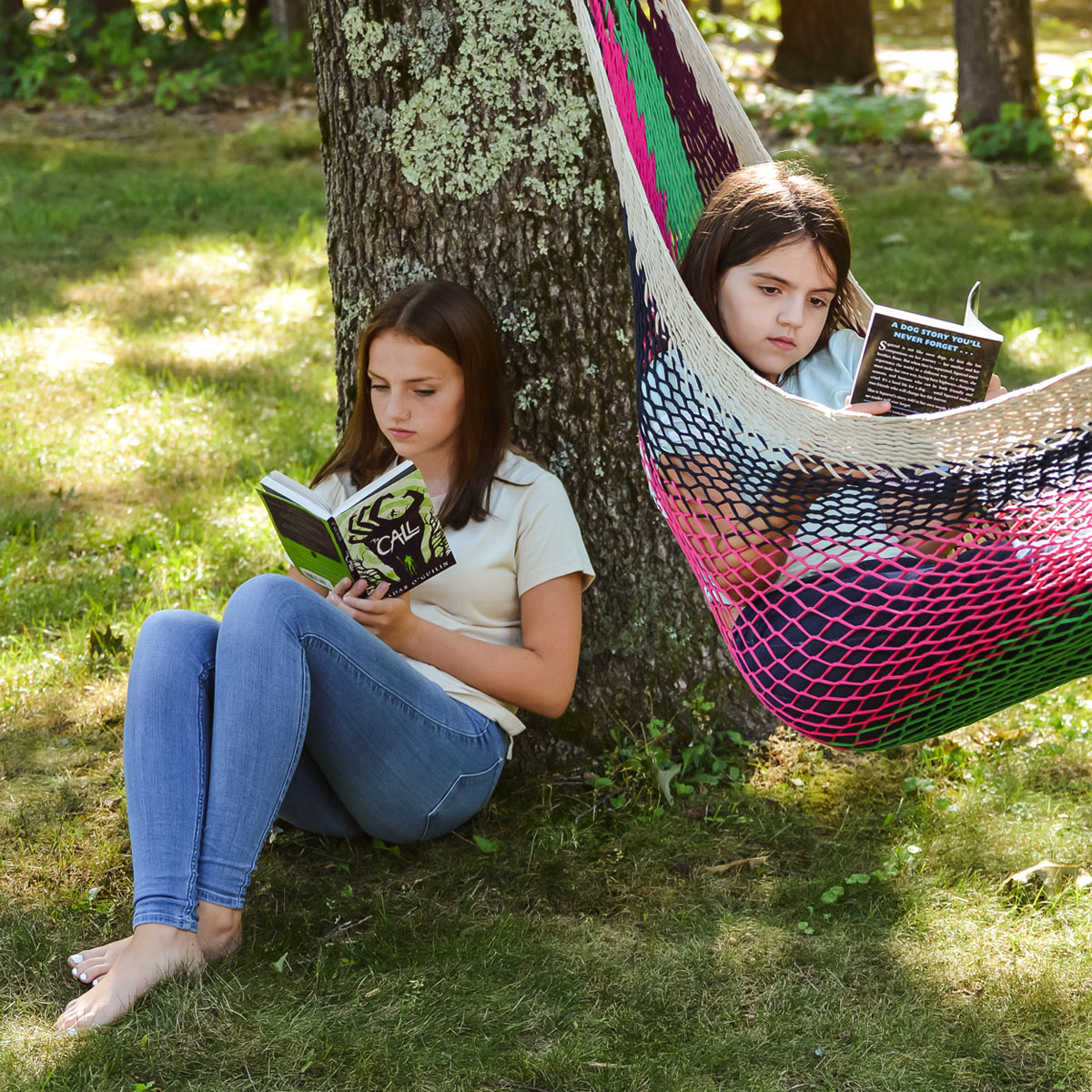 students-in-yard-hammock-reading students outside in yard on grass and in hammock reading