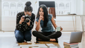 two women photographing cards