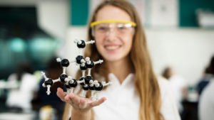 high school girl with chemistry model