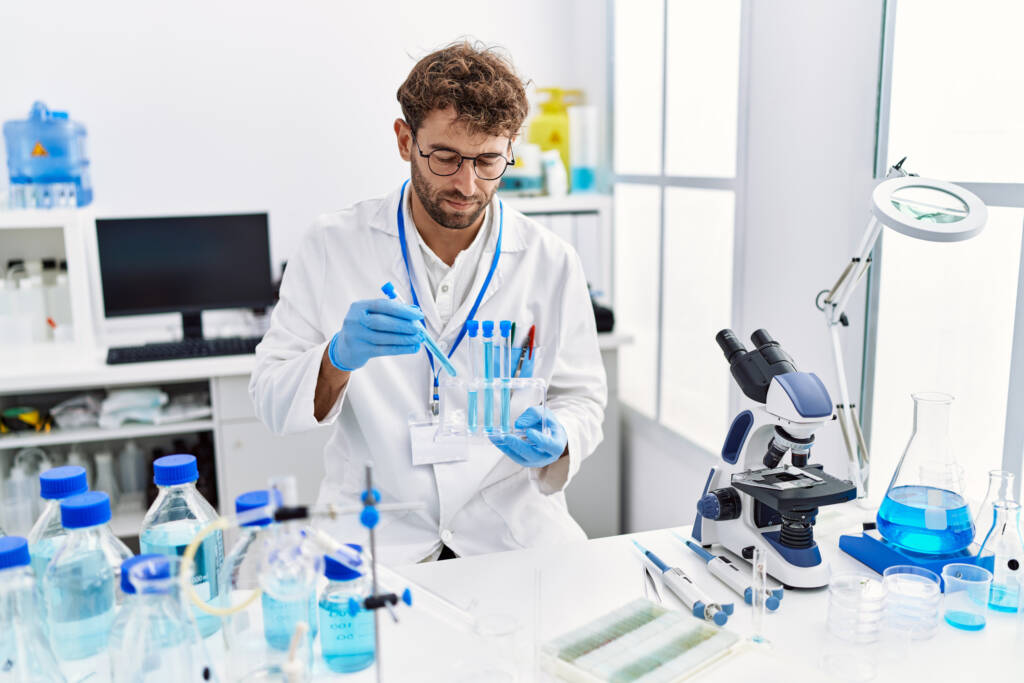man wearing scientist uniform working at laboratory