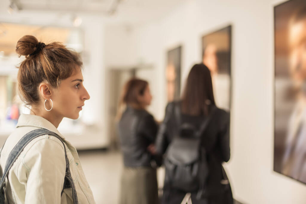 woman looking at modern painting in art gallery. Abstract painting