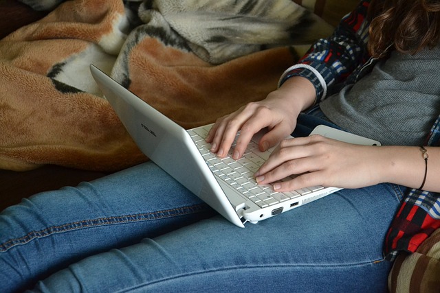 person typing on a laptop